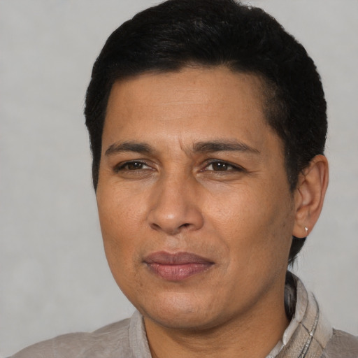Joyful latino young-adult male with short  brown hair and brown eyes