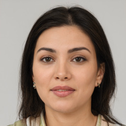 Joyful latino young-adult female with medium  brown hair and brown eyes