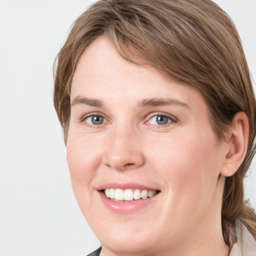 Joyful white young-adult female with medium  brown hair and grey eyes