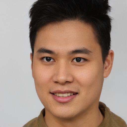 Joyful asian young-adult male with short  brown hair and brown eyes