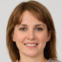 Joyful white young-adult female with medium  brown hair and grey eyes