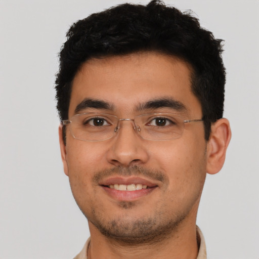 Joyful latino young-adult male with short  brown hair and brown eyes