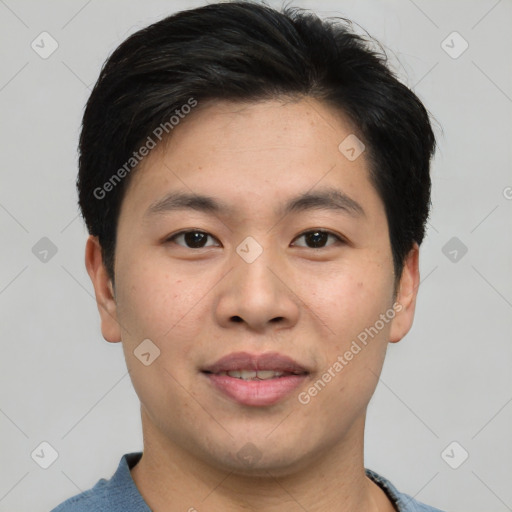 Joyful asian young-adult male with short  brown hair and brown eyes