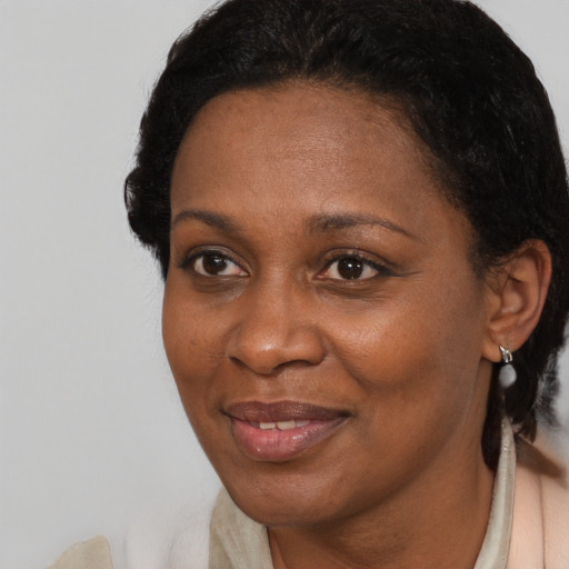 Joyful black adult female with short  brown hair and brown eyes