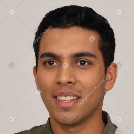 Joyful latino young-adult male with short  black hair and brown eyes