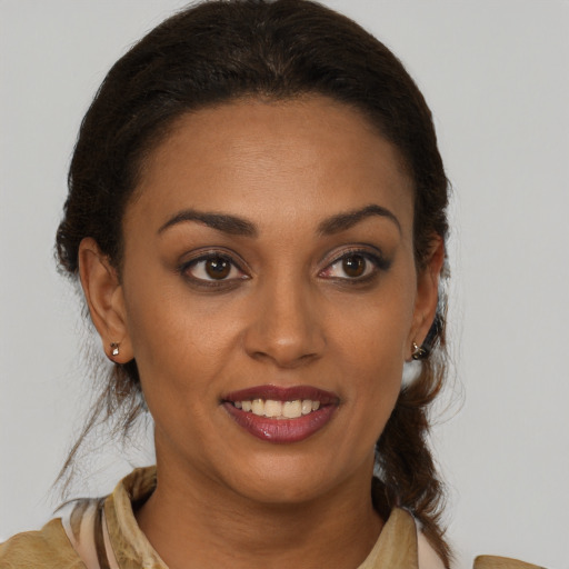 Joyful latino young-adult female with medium  brown hair and brown eyes