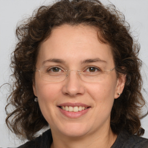 Joyful white adult female with medium  brown hair and brown eyes