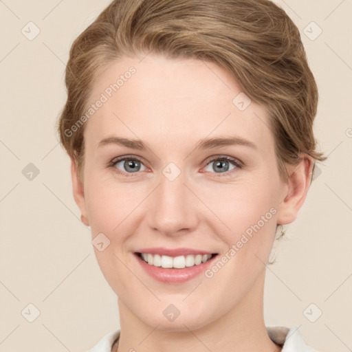 Joyful white young-adult female with short  brown hair and grey eyes