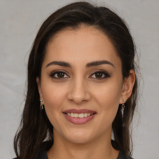 Joyful white young-adult female with long  brown hair and brown eyes