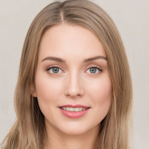 Joyful white young-adult female with long  brown hair and green eyes