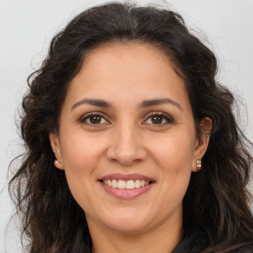Joyful white adult female with long  brown hair and brown eyes