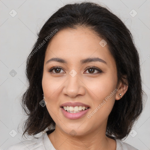 Joyful latino young-adult female with medium  brown hair and brown eyes