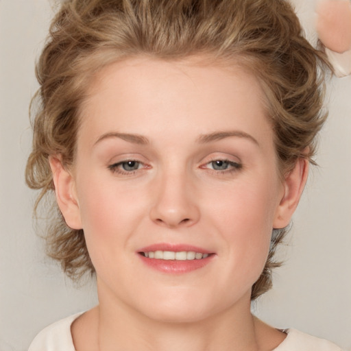 Joyful white young-adult female with medium  brown hair and blue eyes