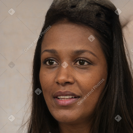 Joyful black young-adult female with long  brown hair and brown eyes