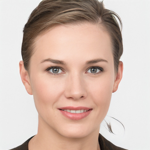 Joyful white young-adult female with medium  brown hair and grey eyes