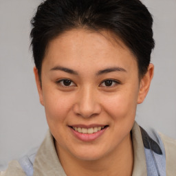 Joyful asian young-adult female with short  brown hair and brown eyes