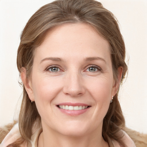 Joyful white young-adult female with medium  brown hair and blue eyes