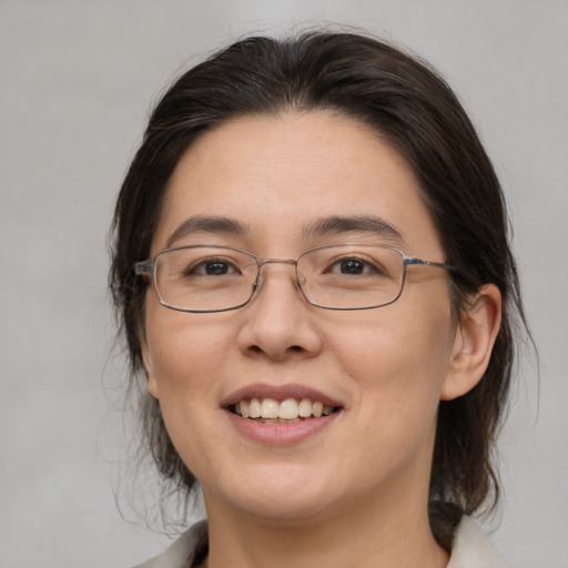 Joyful white adult female with medium  brown hair and brown eyes