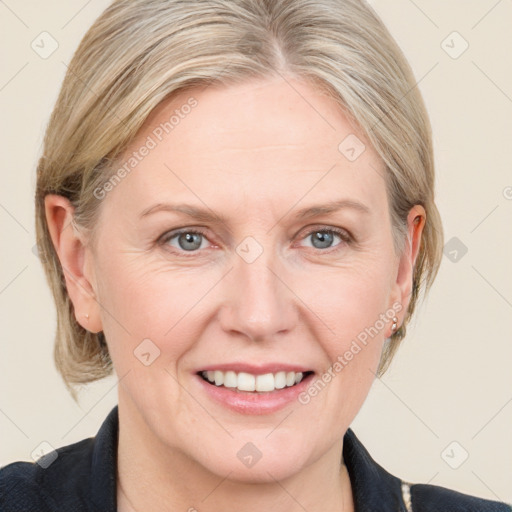 Joyful white adult female with medium  brown hair and blue eyes