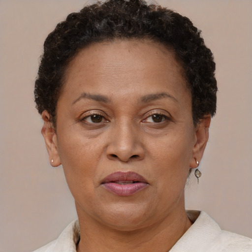 Joyful black adult female with short  brown hair and brown eyes