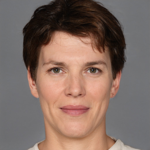 Joyful white adult female with short  brown hair and grey eyes