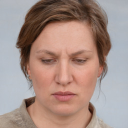 Joyful white adult female with medium  brown hair and blue eyes