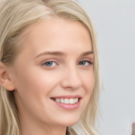 Joyful white young-adult female with long  blond hair and blue eyes