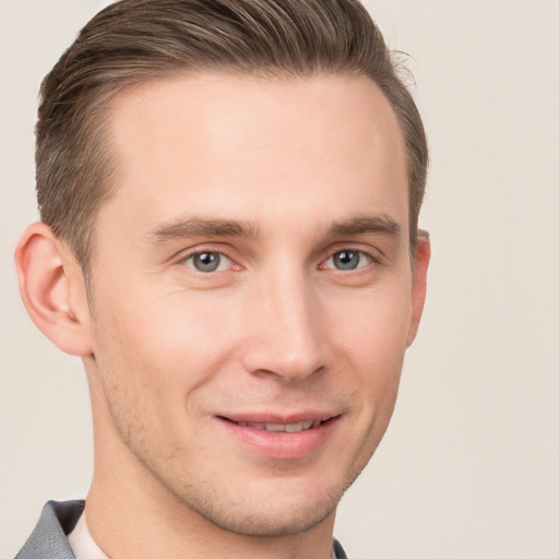 Joyful white young-adult male with short  brown hair and grey eyes