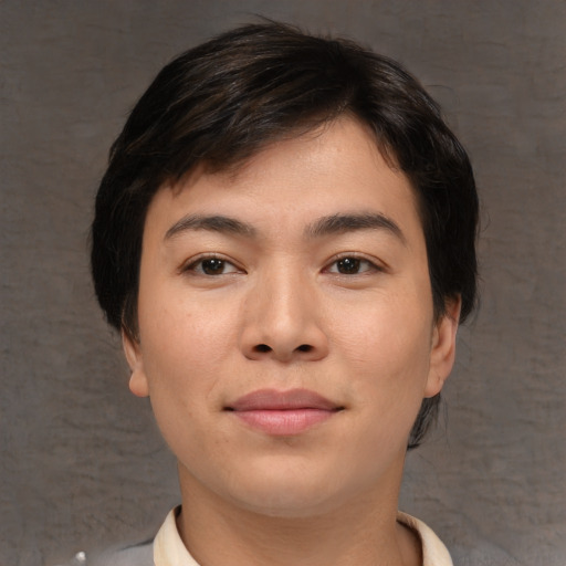 Joyful asian young-adult male with short  brown hair and brown eyes