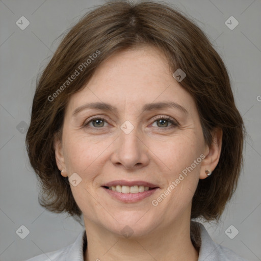 Joyful white adult female with medium  brown hair and grey eyes