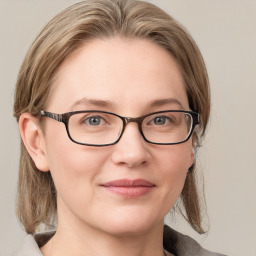 Joyful white adult female with medium  brown hair and blue eyes