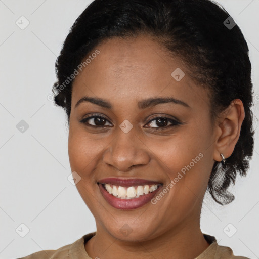 Joyful black young-adult female with short  brown hair and brown eyes