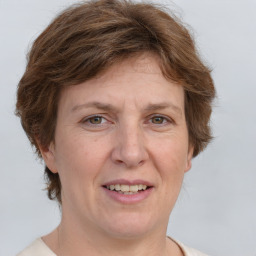 Joyful white adult female with medium  brown hair and grey eyes