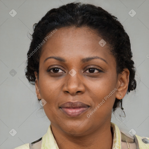 Joyful black adult female with medium  brown hair and brown eyes