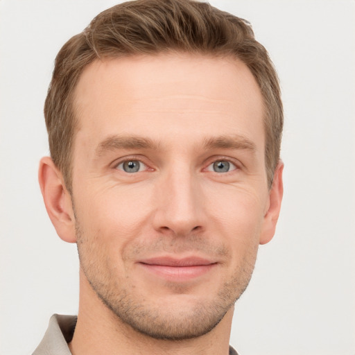 Joyful white young-adult male with short  brown hair and grey eyes