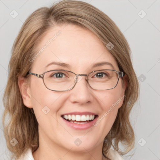 Joyful white adult female with medium  brown hair and blue eyes