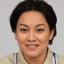 Joyful asian adult female with medium  brown hair and brown eyes