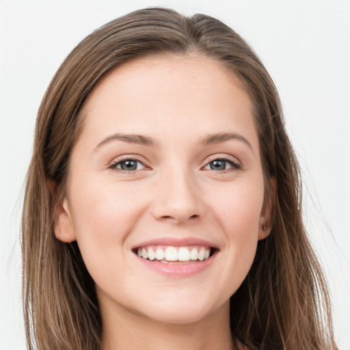 Joyful white young-adult female with long  brown hair and grey eyes