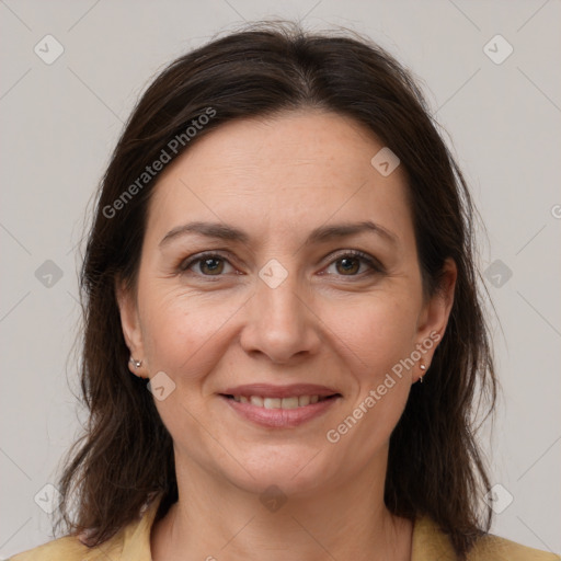 Joyful white adult female with medium  brown hair and brown eyes