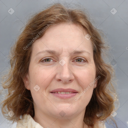 Joyful white adult female with medium  brown hair and blue eyes