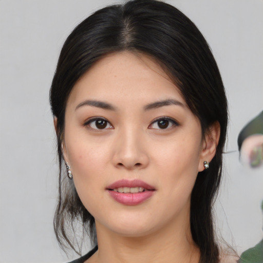 Joyful white young-adult female with medium  black hair and brown eyes