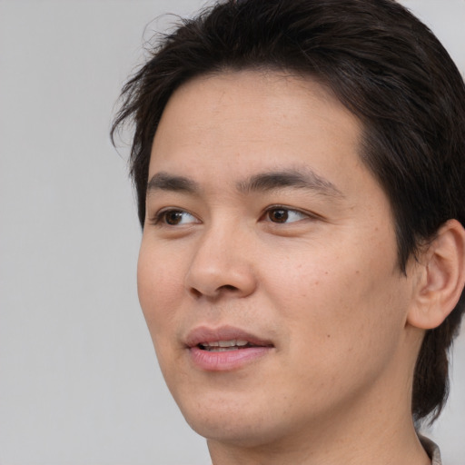 Joyful white young-adult male with medium  brown hair and brown eyes