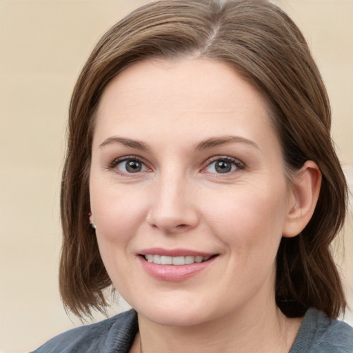 Joyful white young-adult female with medium  brown hair and blue eyes