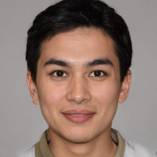 Joyful latino young-adult male with short  brown hair and brown eyes