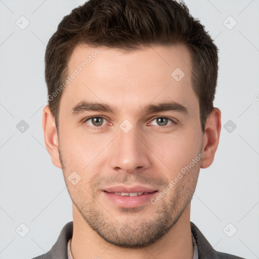 Joyful white young-adult male with short  brown hair and brown eyes