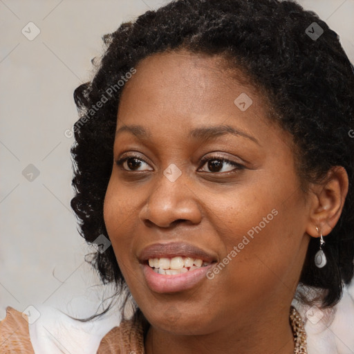 Joyful black young-adult female with medium  brown hair and brown eyes