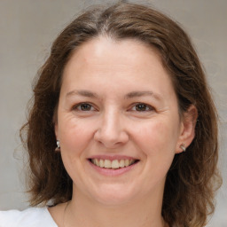 Joyful white adult female with medium  brown hair and brown eyes