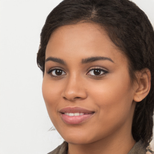 Joyful latino young-adult female with long  brown hair and brown eyes