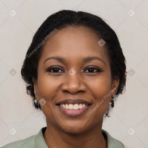 Joyful black young-adult female with long  black hair and brown eyes