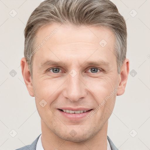 Joyful white adult male with short  brown hair and grey eyes